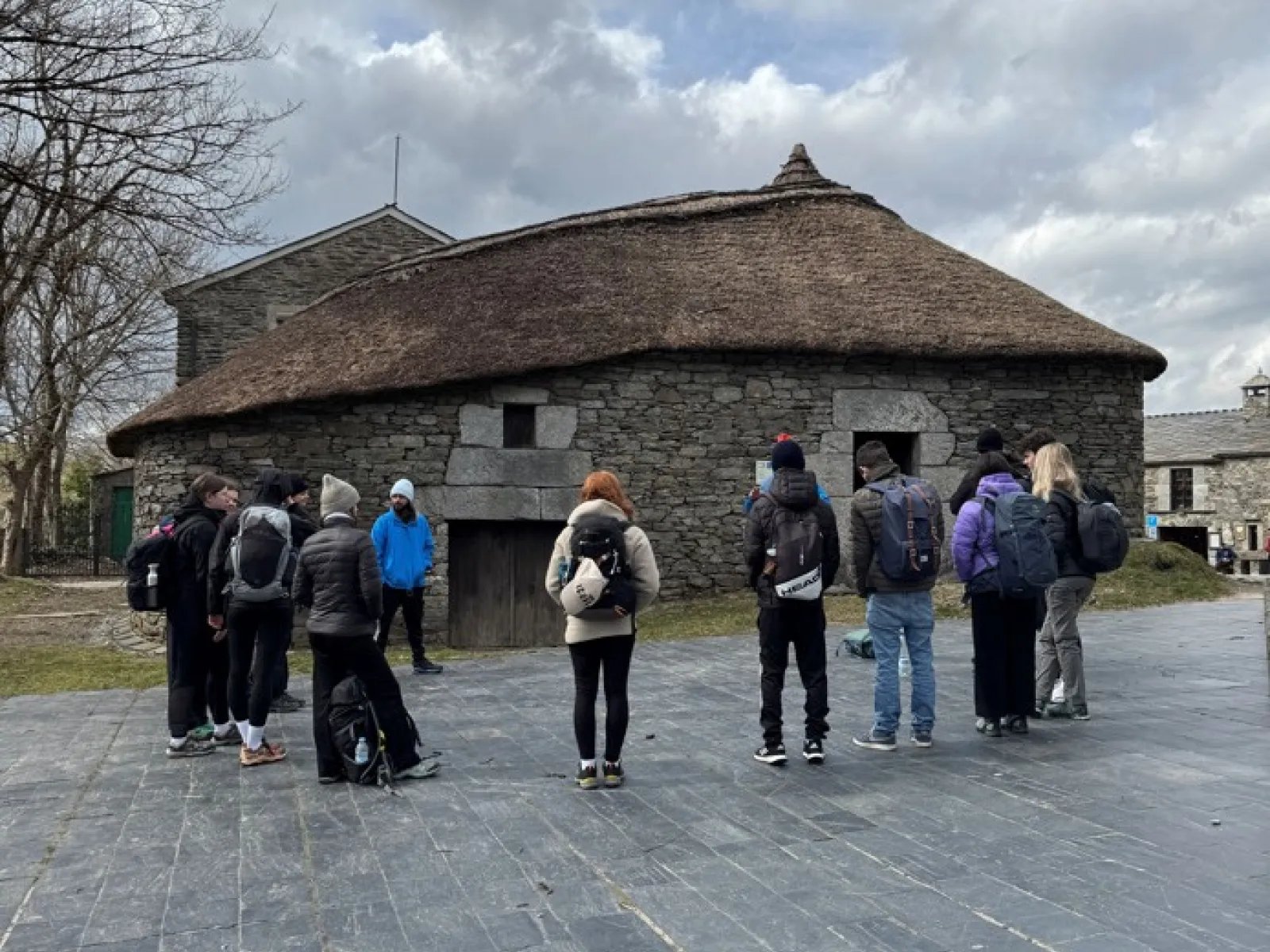 Gruppe von Studierenden schaut auf ein historisches Steingebäude in Portugal