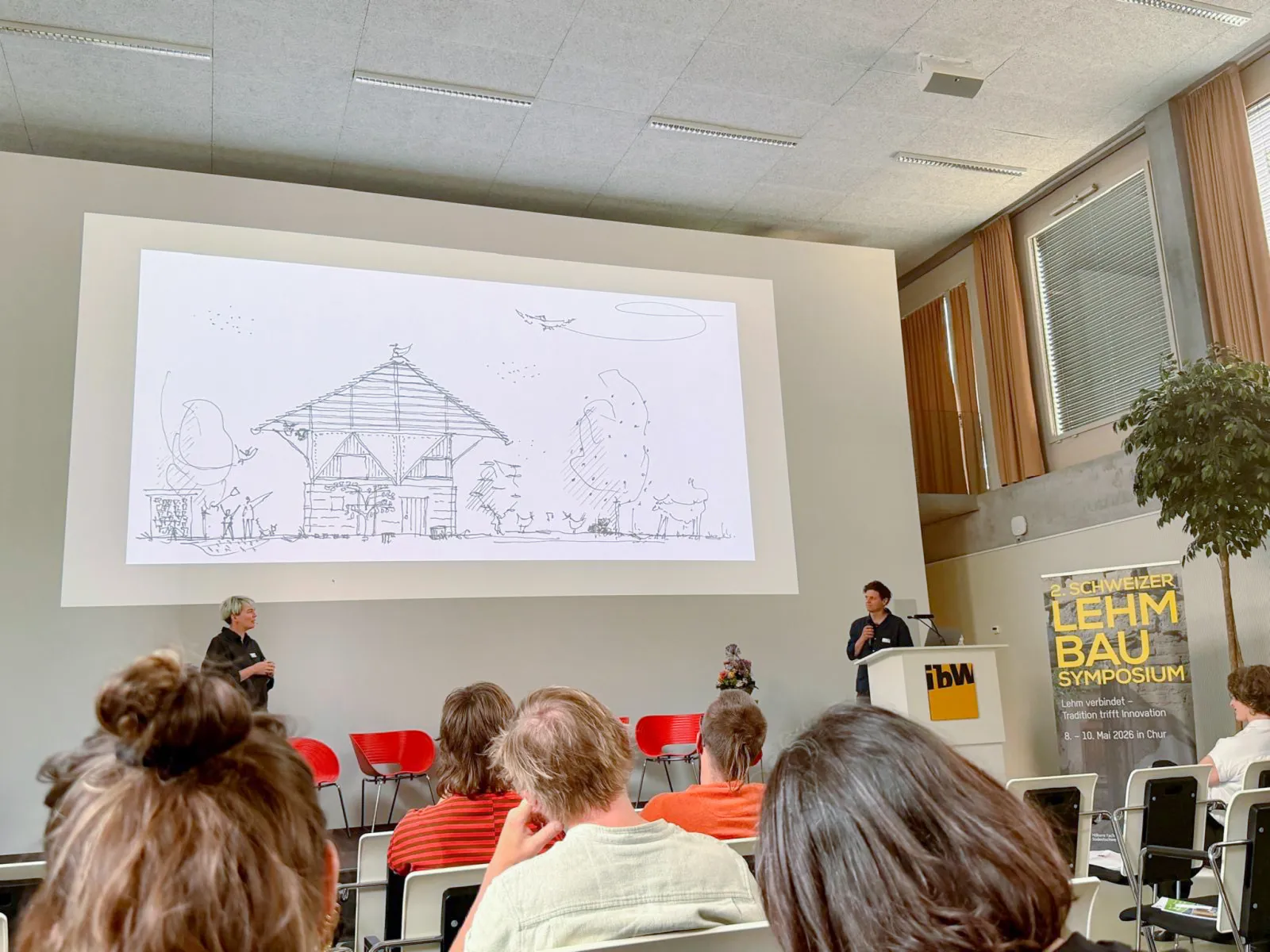Eine architektonische Skizze, die auf eine Leinwand projiziert wird