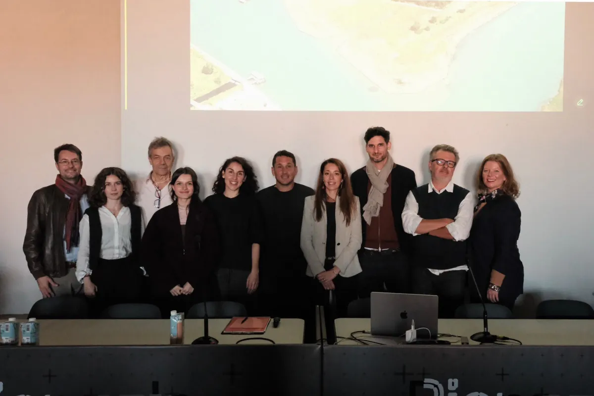 Ein Gruppenbild von 10 Personen vor einer Leinwand