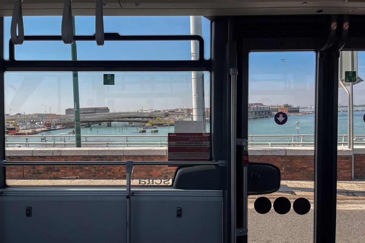 View from a bus onto water and harbor.