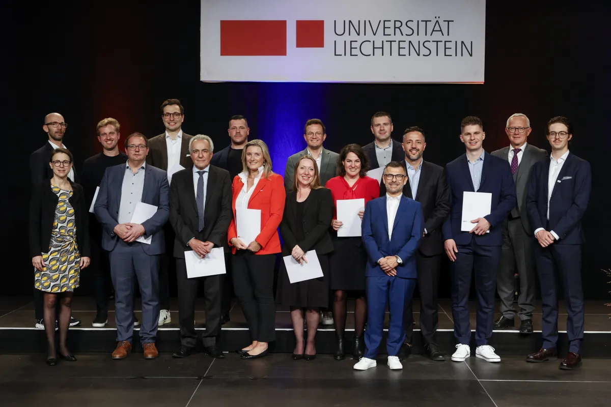 MBA graduates holding their certificates at the University of Liechtenstein graduation ceremony