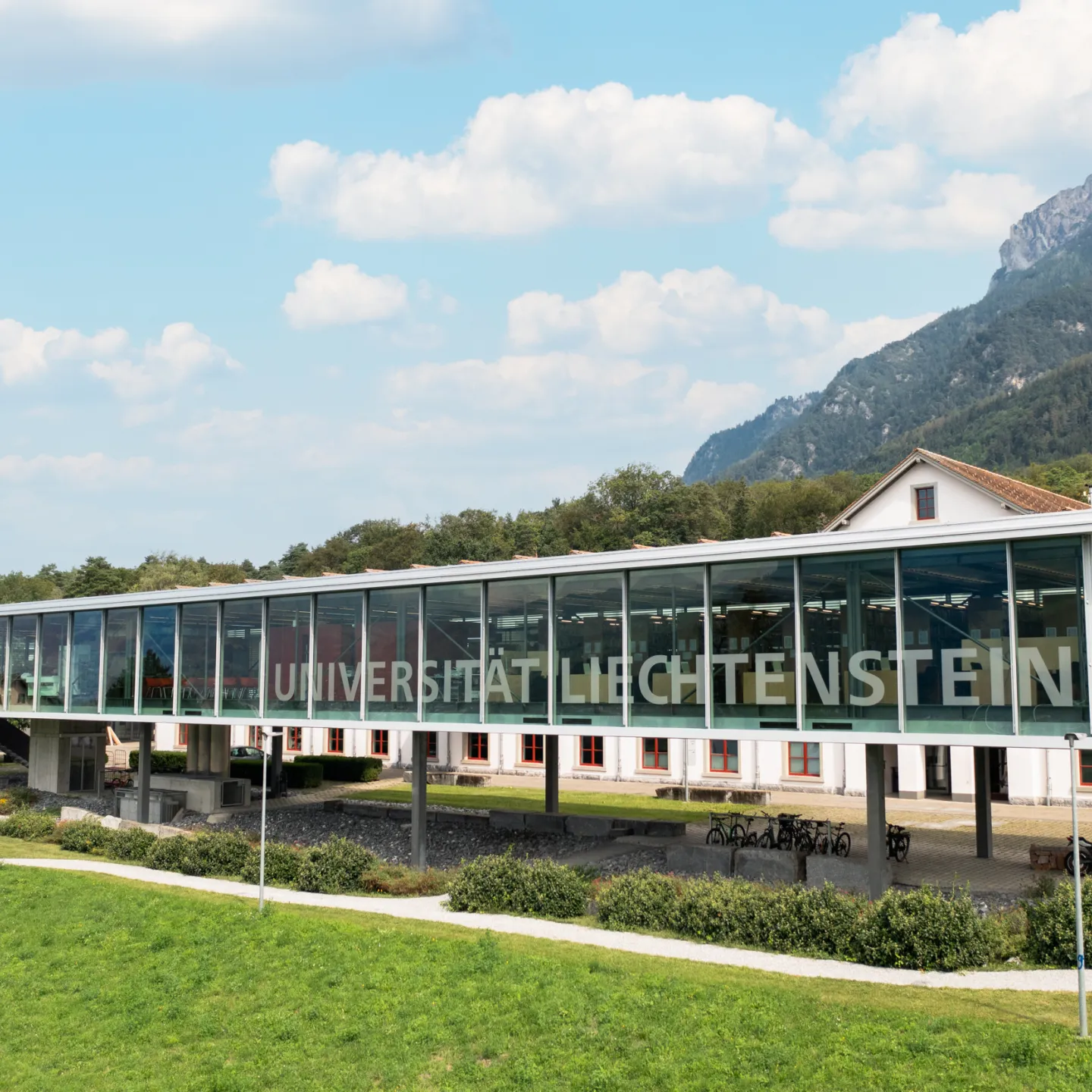 Modern Glass Façade of the University of Liechtenstein with a View of the Alpine Panorama