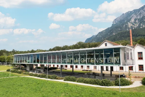Modern Glass Façade of the University of Liechtenstein with a View of the Alpine Panorama