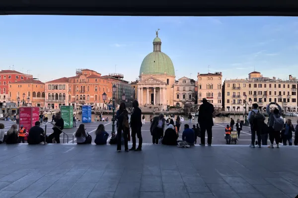 View of a square with domed building and people.